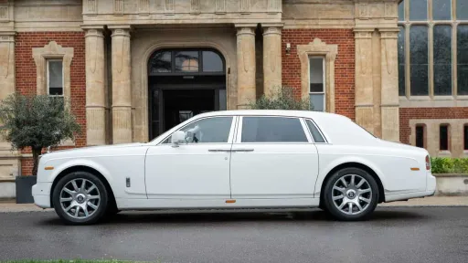 Full side profile of white Rolls-Royce Phantom Series II EWB showing extended wheelbase body design.