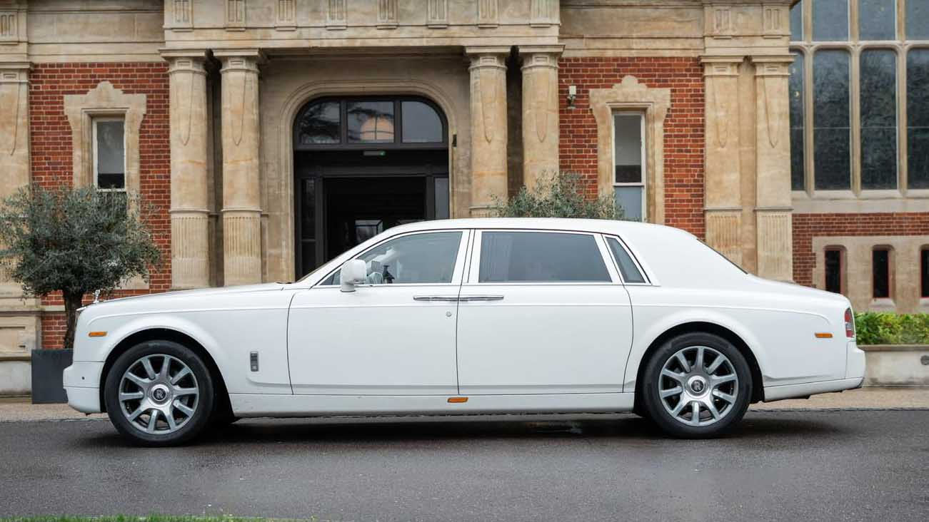 Full side profile of white Rolls-Royce Phantom Series II EWB showing extended wheelbase body design.
