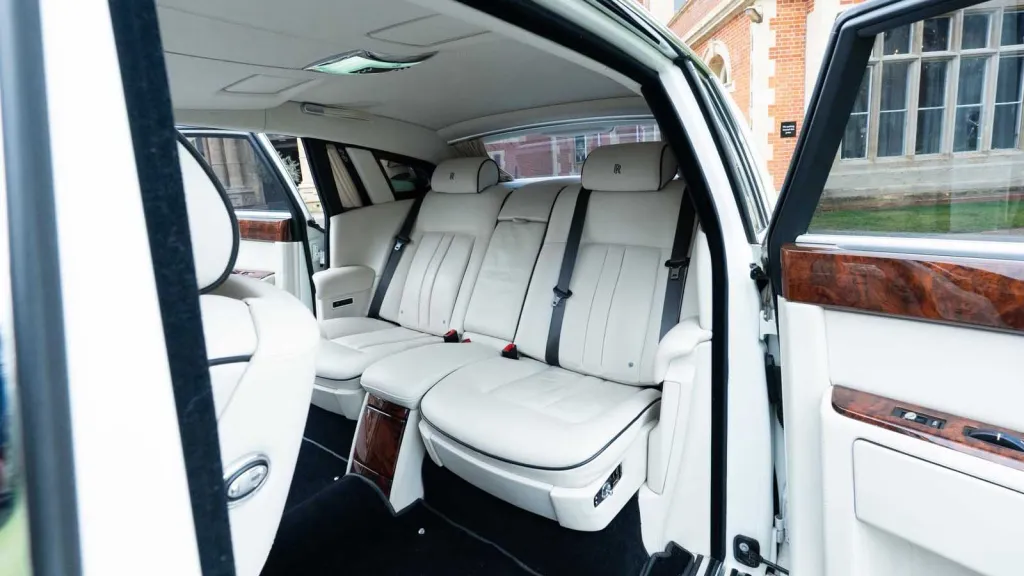 Spacious rear cabin inside Rolls-Royce Phantom Series II EWB with luxury white leather seating.
