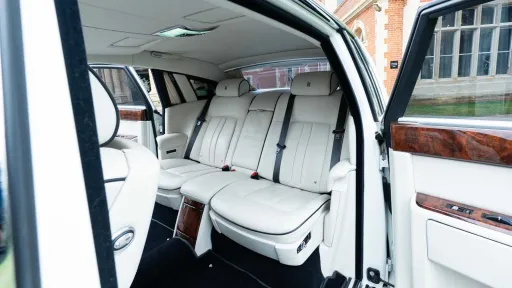 Spacious rear cabin inside Rolls-Royce Phantom Series II EWB with luxury white leather seating.