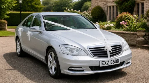 Three Quarter view of silver Mercedes S-class dresses with white ribbons and bows