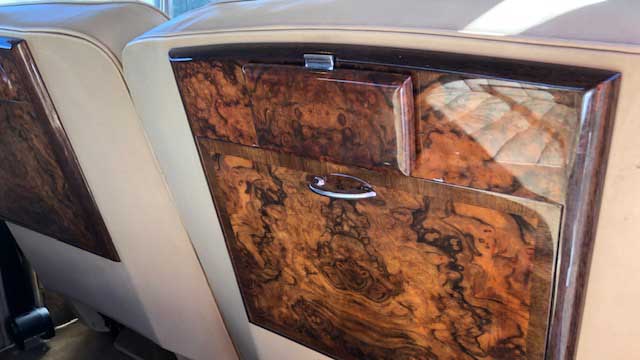 Fold down wooden picnic table inside rear cabin of classic Rolls-Royce Silver Cloud.