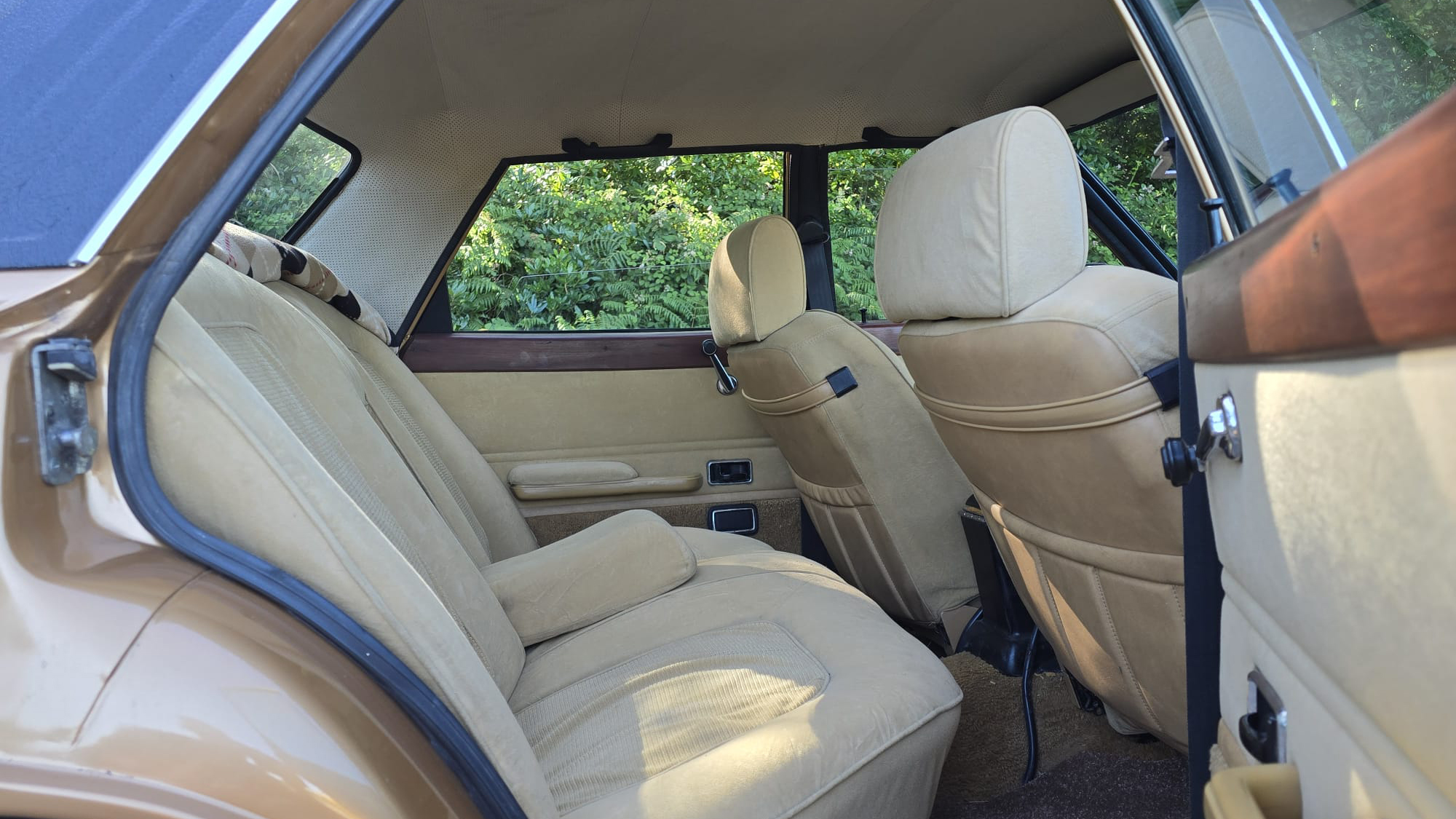 Rear cream cloth seating inside 1977 Ford Cortina Mk4 Ghia with spacious passenger cabin.