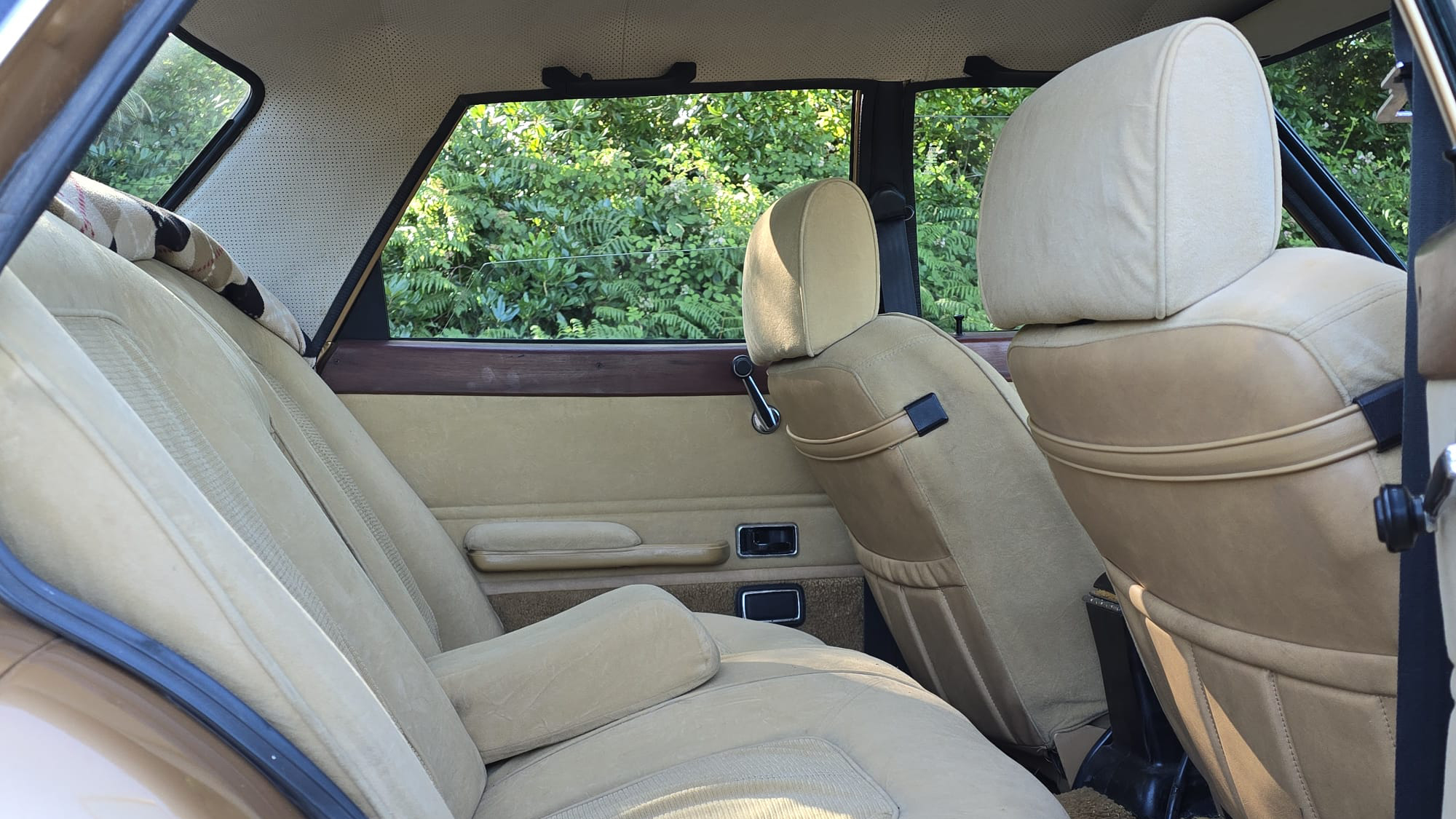 Cream cloth rear seating inside classic 1977 Ford Cortina Mk4 Ghia.