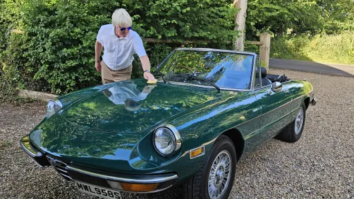 1978 Alfa Romeo Spider Veloce 2000 convertible in green parked outdoors for wedding hire in Wiltshire.