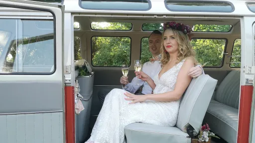 Bride seated inside 1962 Volkswagen Split Screen 23 Window Microbus showing spacious rear seating.