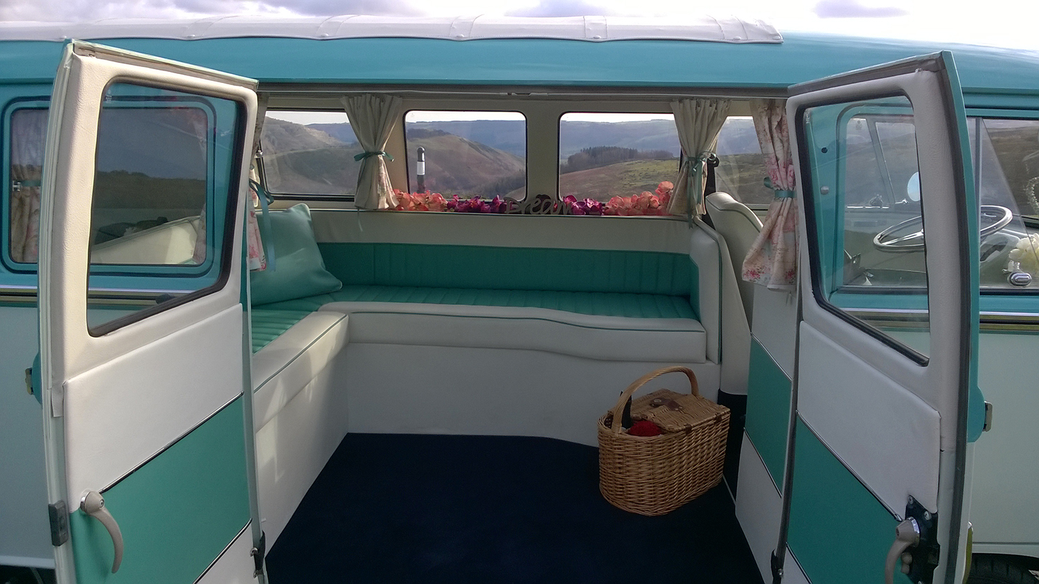 Blue and white rear L-shape seating inside 1967 Volkswagen Split Screen campervan