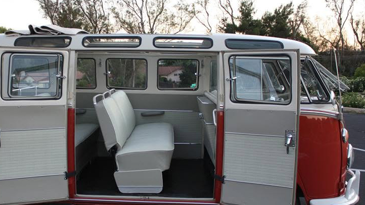 Rear seating area inside 1962 Volkswagen Split Screen Microbus viewed through the open side doors.