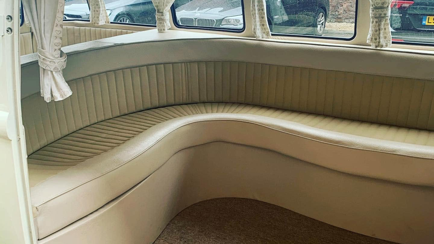 Cream L shaped rear seating inside 1972 Volkswagen Split Screen campervan.