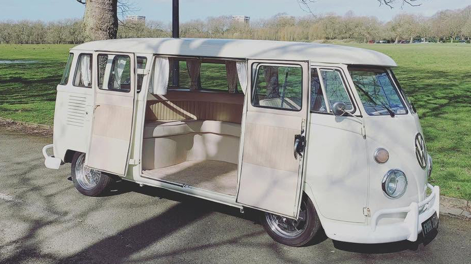 Cream 1972 Volkswagen Split Screen campervan with twin rear side doors open showing the interior.
