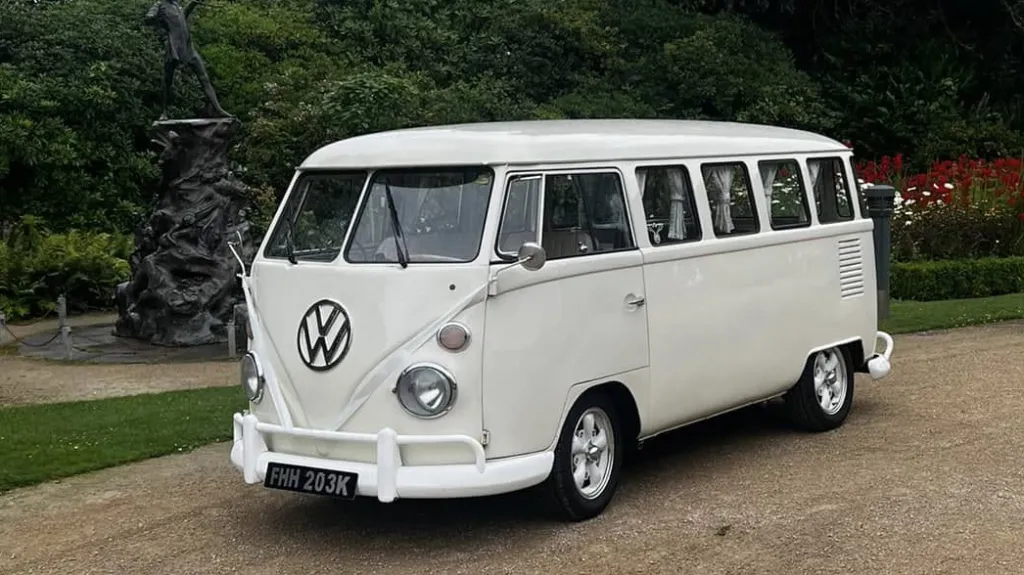 Front three quarter view of cream 1972 Volkswagen Split Screen campervan parked at wedding venue in Liverpool.