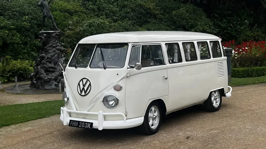 Front three quarter view of cream 1972 Volkswagen Split Screen campervan parked at wedding venue in Liverpool.