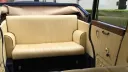 Cream leather rear seating inside navy blue and ivory Bramwith Landaulette showing spacious vintage interior.