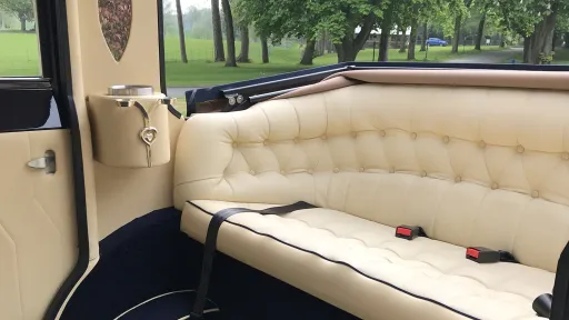 Forward facing cream leather rear seating inside Imperial Landaulette wedding car.