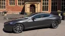 Left side view of metallic silver Aston Martin Rapide S V12 four door luxury sports car outside a wedding venue.