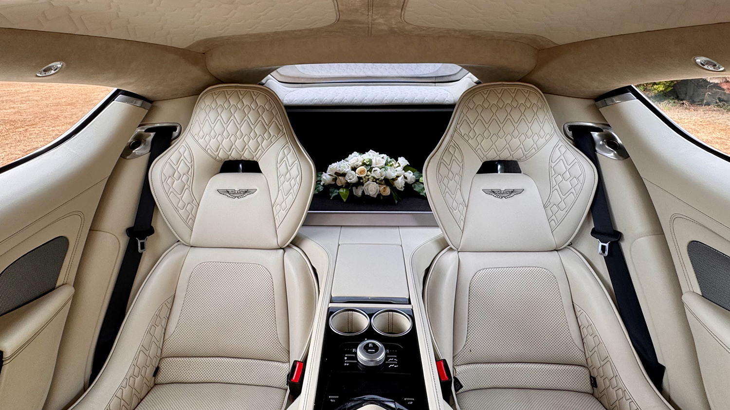 Quilted cream leather rear passenger seats inside Aston Martin Rapide S with individual seating and centre armrest.