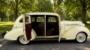 Cream 1937 Hudson Terraplane with passenger doors open showing the maroon red leather interior.