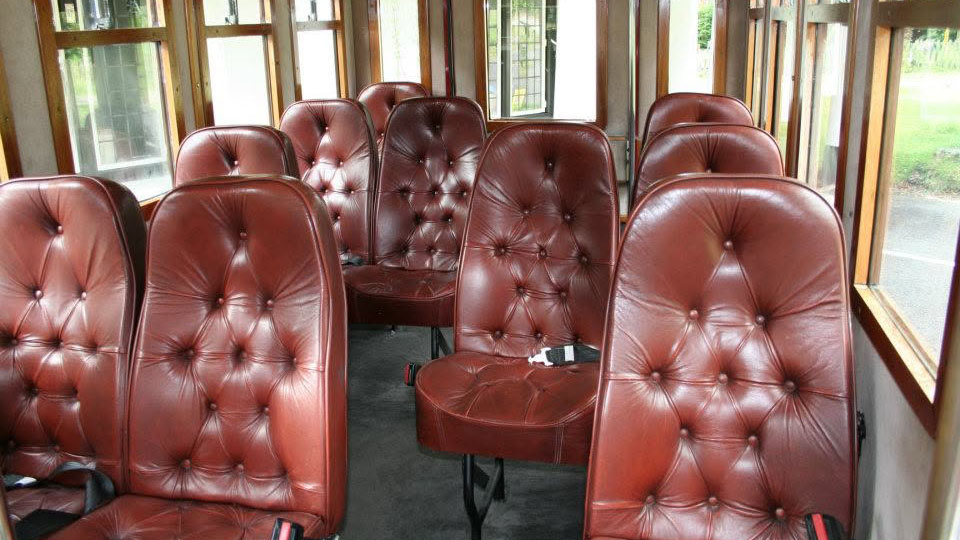 Brown leather passenger seats inside the Asquith Mascot vintage wedding bus