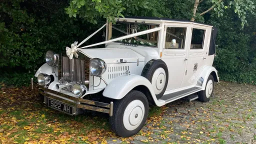 Front right view of the white Imperial Viscount Landaulette wedding car with vintage chrome detailing