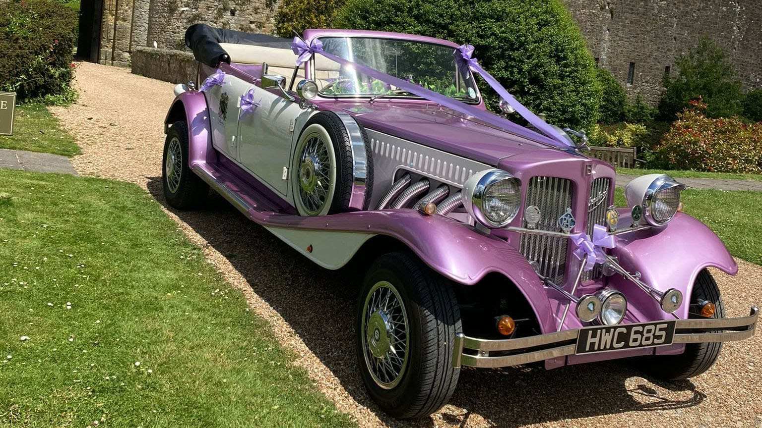 Front three-quarter view of the lilac and white Beauford Convertible vintage-style wedding car in Hampshire