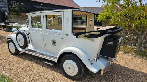 Left rear view of the white Imperial Viscount Landaulette with its rear convertible roof open