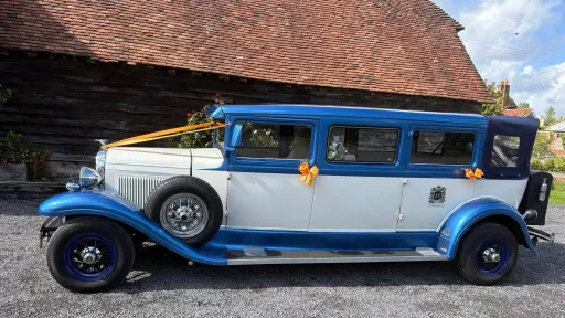 Left side view of the blue and white Bramwith Landaulette 7-seater wedding car