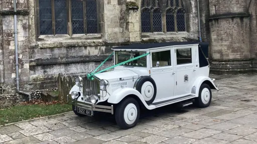 Left side view of the white Imperial Viscount Landaulette wedding limousine in Waterlooville