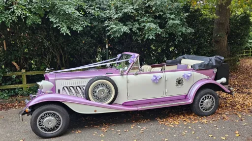 Left side view of the two-tone lilac and white four-door Beauford Convertible with the roof lowered