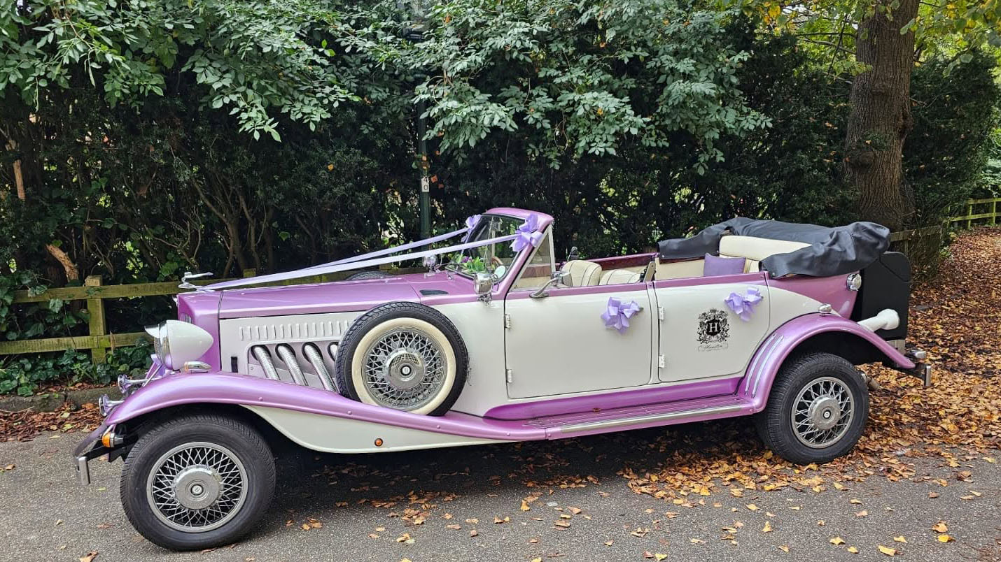 Left side view of the two-tone lilac and white four-door Beauford Convertible with the roof lowered