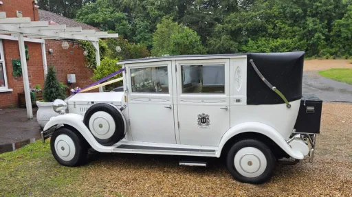 Left side view of the white Imperial Viscount Landaulette with its black soft-top rear roof closed