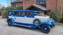 Right side view of the blue and white Bramwith Landaulette parked outside a church in Waterlooville