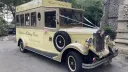 Front three-quarter view of the cream and gold Asquith Mascot 8-passenger wedding bus