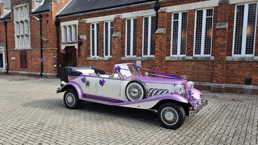 Two-tone lilac and white four-door Beauford Convertible wedding car parked in Hampshire with its roof lowered