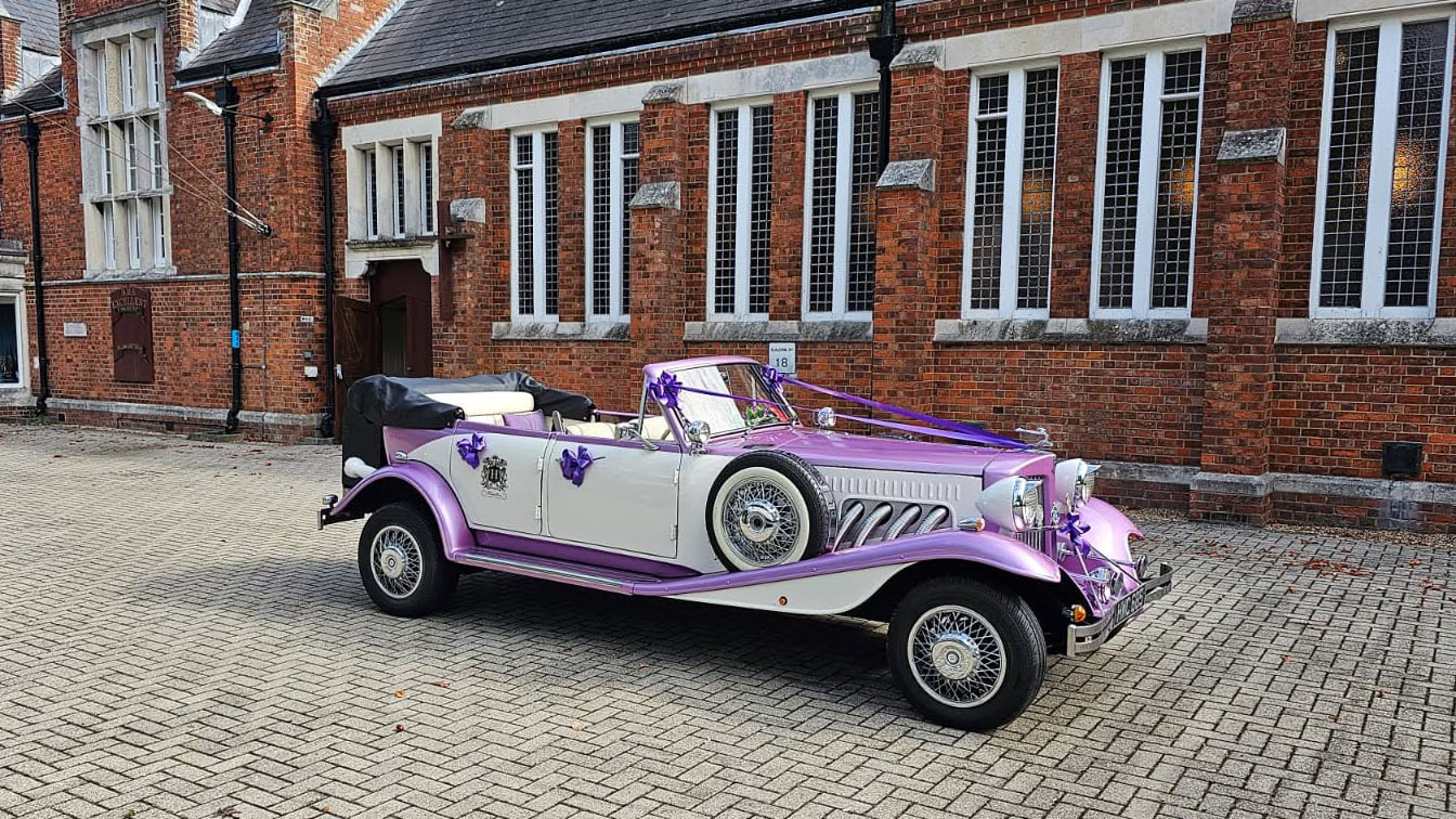 Two-tone lilac and white four-door Beauford Convertible wedding car parked in Hampshire with its roof lowered