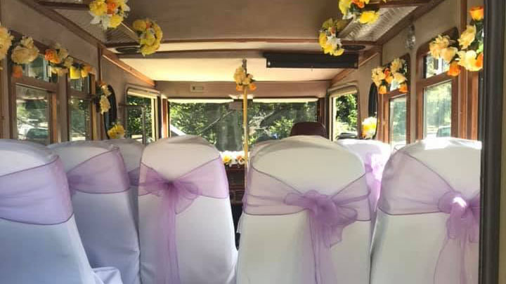 Interior of the Asquith Mascot wedding bus decorated for a wedding with seat covers and bows