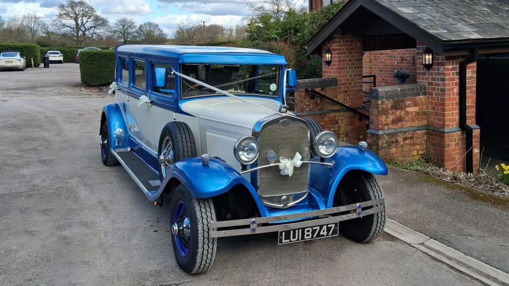 Front view of the blue and white Bramwith Landaulette 7-passenger wedding car for hire in Portsmouth