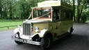 Front view of the cream and gold Asquith Mascot 8-seater vintage wedding bus