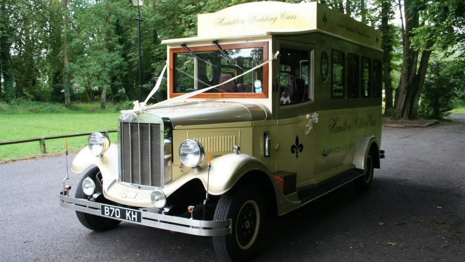 Front view of the cream and gold Asquith Mascot 8-seater vintage wedding bus