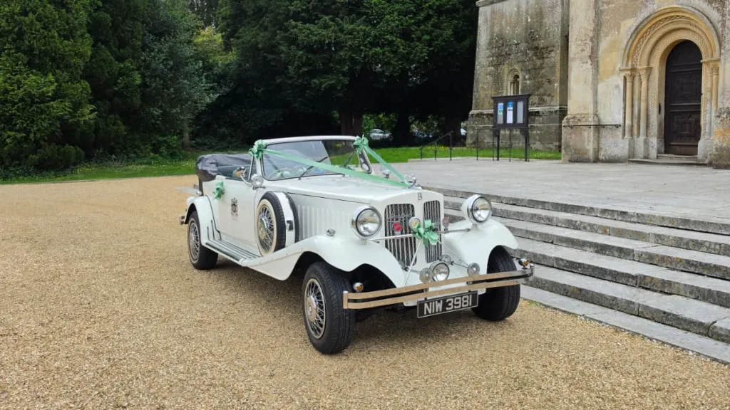 White Beauford Convertible wedding car parked outside a church near Portsmouth with its roof lowered