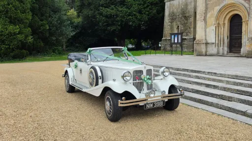 White Beauford Convertible wedding car parked outside a church near Portsmouth with its roof lowered