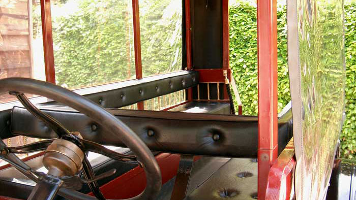 Interior of 1914 Ford Model T Charabanc showing driver area and wooden steering wheel
