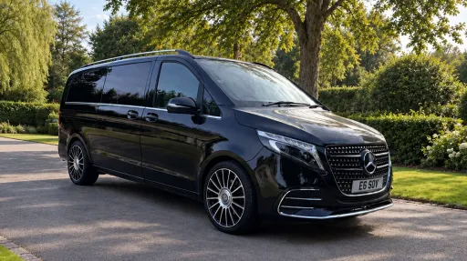 Black Mercedes V-Class Landjets luxury wedding vehicle parked in a green park setting