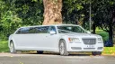 Front right side view white chrysler limousine with privacy windows