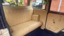 Cream leather passenger seating inside the Bramwith Landaulette wedding car.