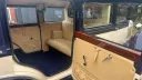 Open passenger door showing the Bramwith Landaulette’s cream leather interior and entrance step.