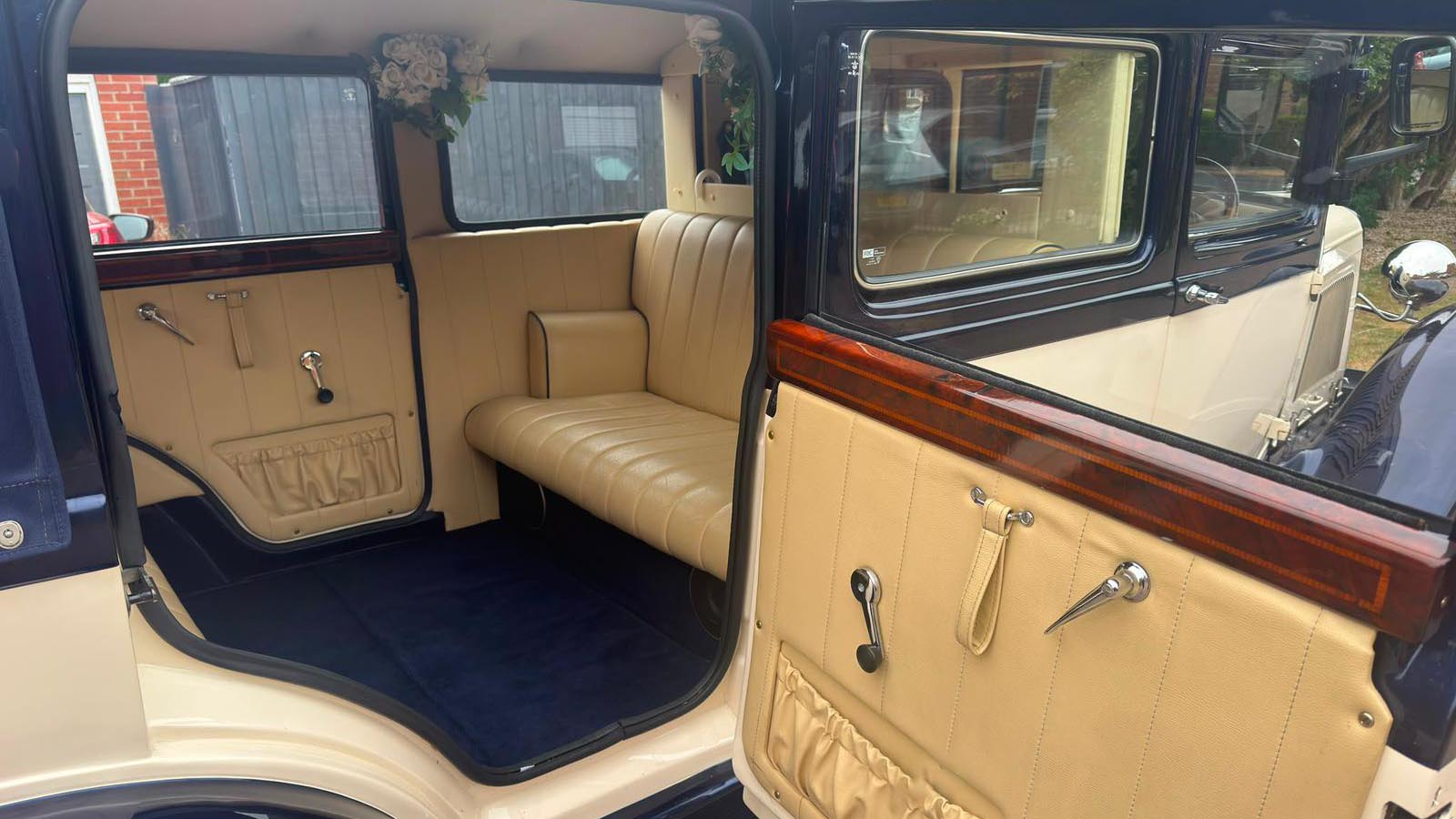 Open passenger door showing the Bramwith Landaulette’s cream leather interior and entrance step.