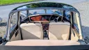 View through the open rear roof of a Royale Windsor Landaulette showing cream upholstery and the wood dashboard.