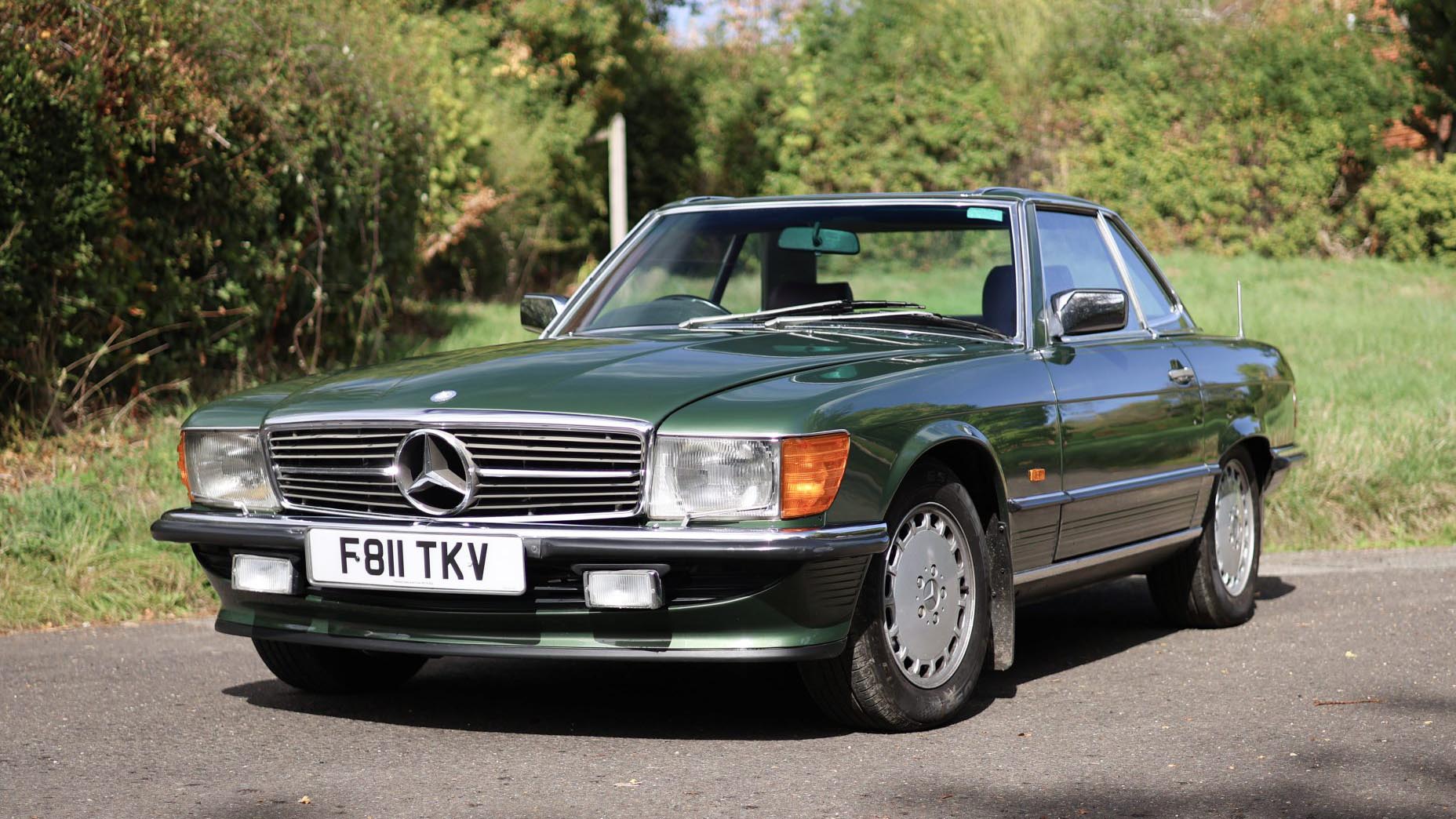 Front view of a green 1989 Mercedes-Benz 420 SL wedding car with its hardtop fitted