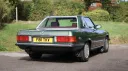 Rear view of a green 1989 Mercedes-Benz 420 SL wedding car with its hardtop fitted