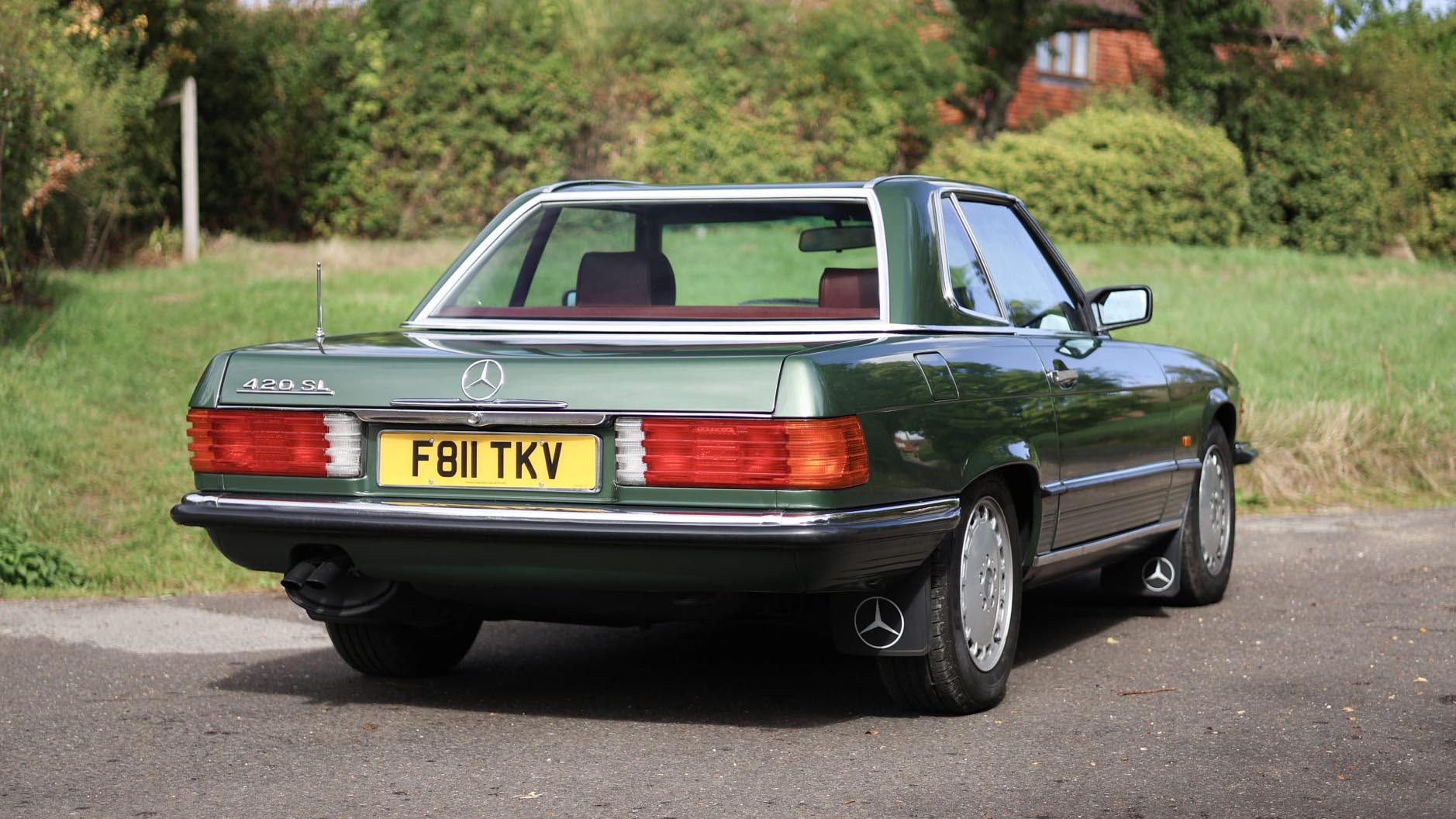 Rear view of a green 1989 Mercedes-Benz 420 SL wedding car with its hardtop fitted
